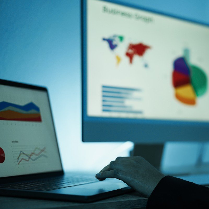Young woman analyzing data charts for marketing financial reports - Focus on left hand
